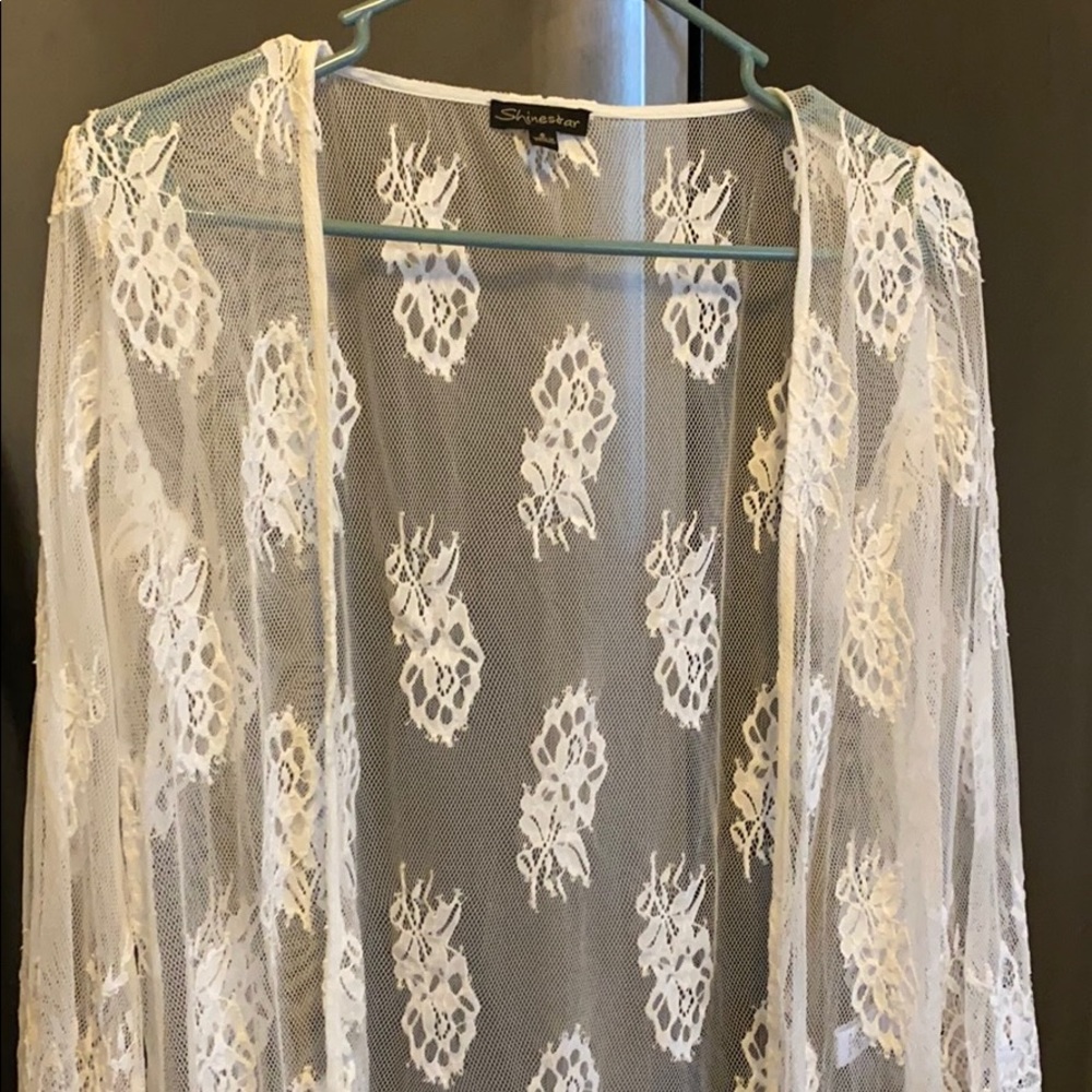 White fringe kimono with slits on the side.